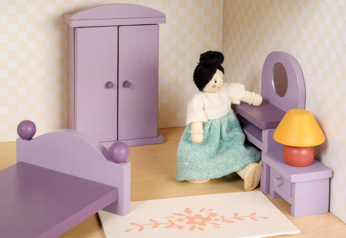 Wooden doll house bedroom set with purple furniture including bed, wardrobe, dressing table, stool, lamp, and a rug with floral design