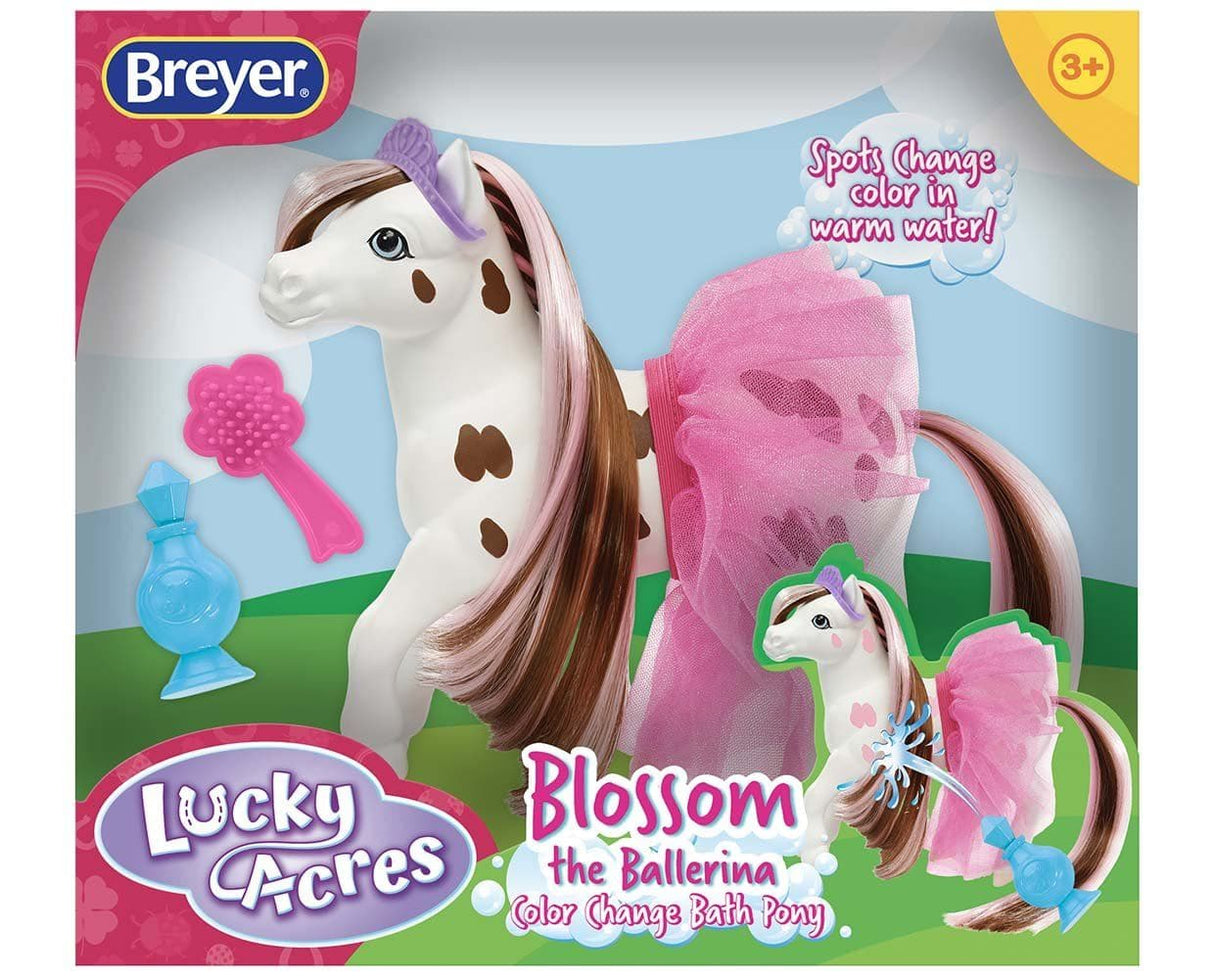 Blossom Color Change Horse toy with pink tutu, brush, perfume bottle, and brown spots that change color in warm water.