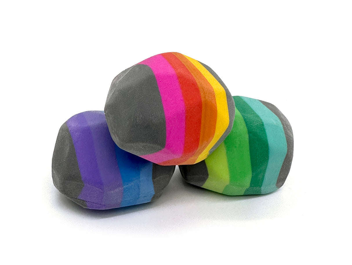Box of Rocks Erasers featuring three colorful rock-shaped erasers with vibrant striped middles for kids ages 3 and up.