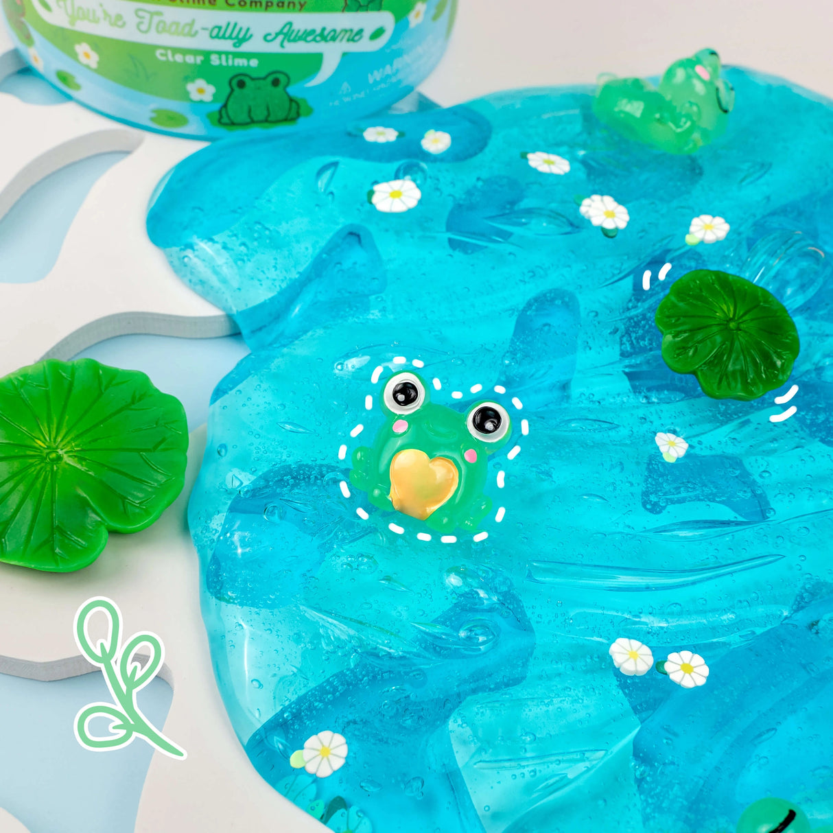 You're Toad-ally Awesome Clear Slime with bright blue color, water lily scent, and cute toad charms for playful fun.