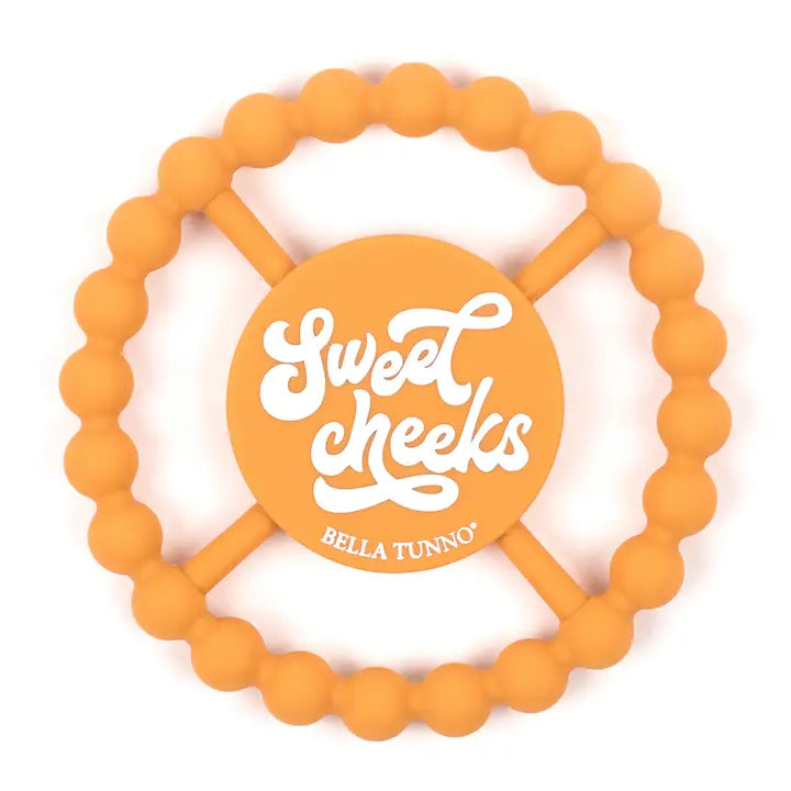 Teether | Sweet Cheeks silicone teether in orange with easy grip and soothing design for babies' sore gums.