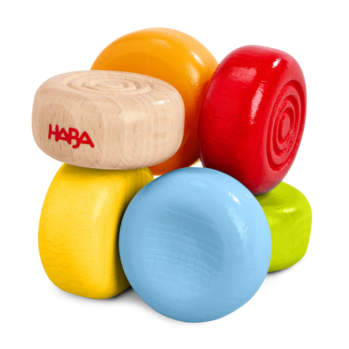 Colorful wooden drops of a grasping and teething toy stacked together for babies six months and older.