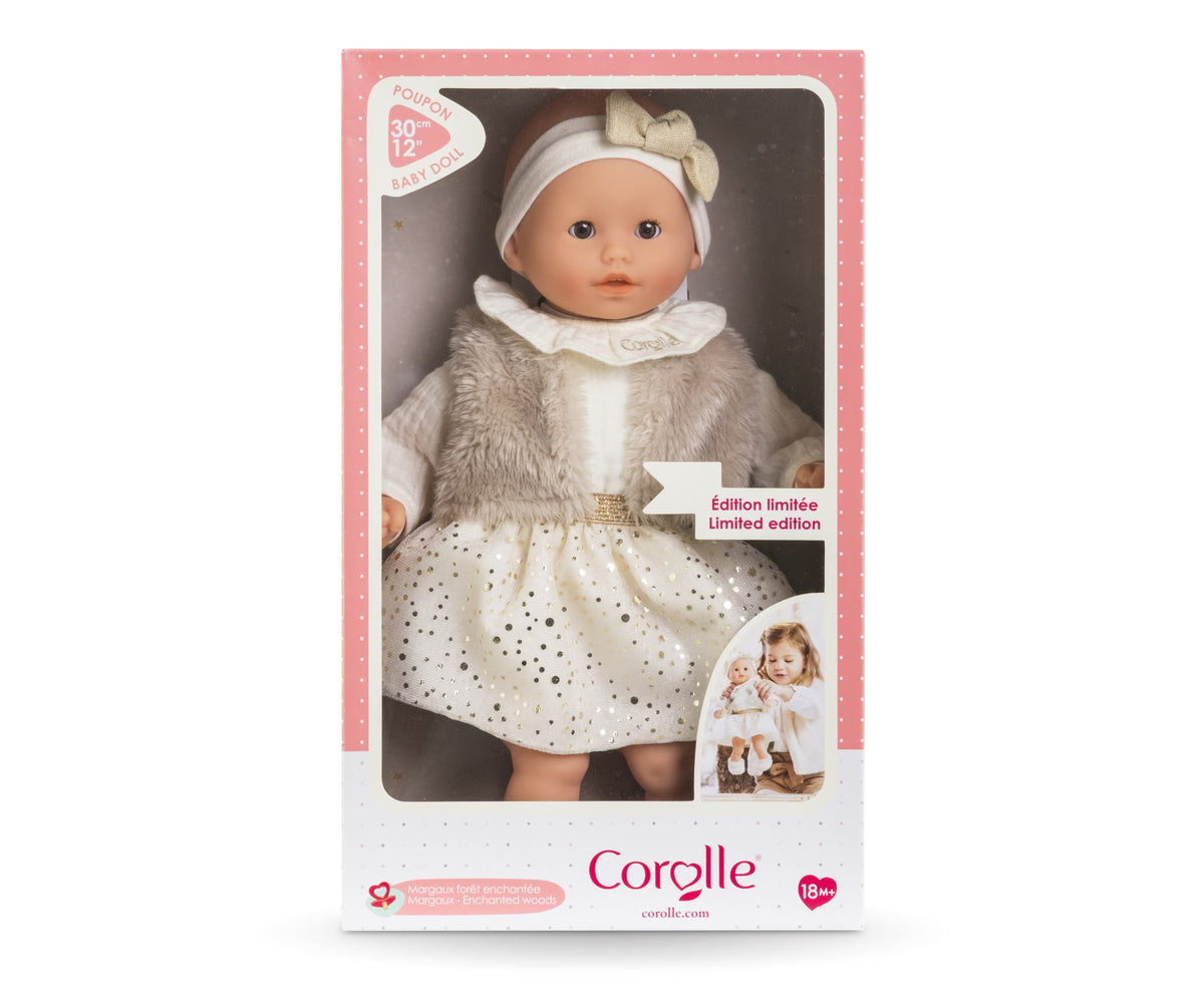 Calin Margaux Enchanted Woods doll in a pink box wearing a cream dress and gray coat