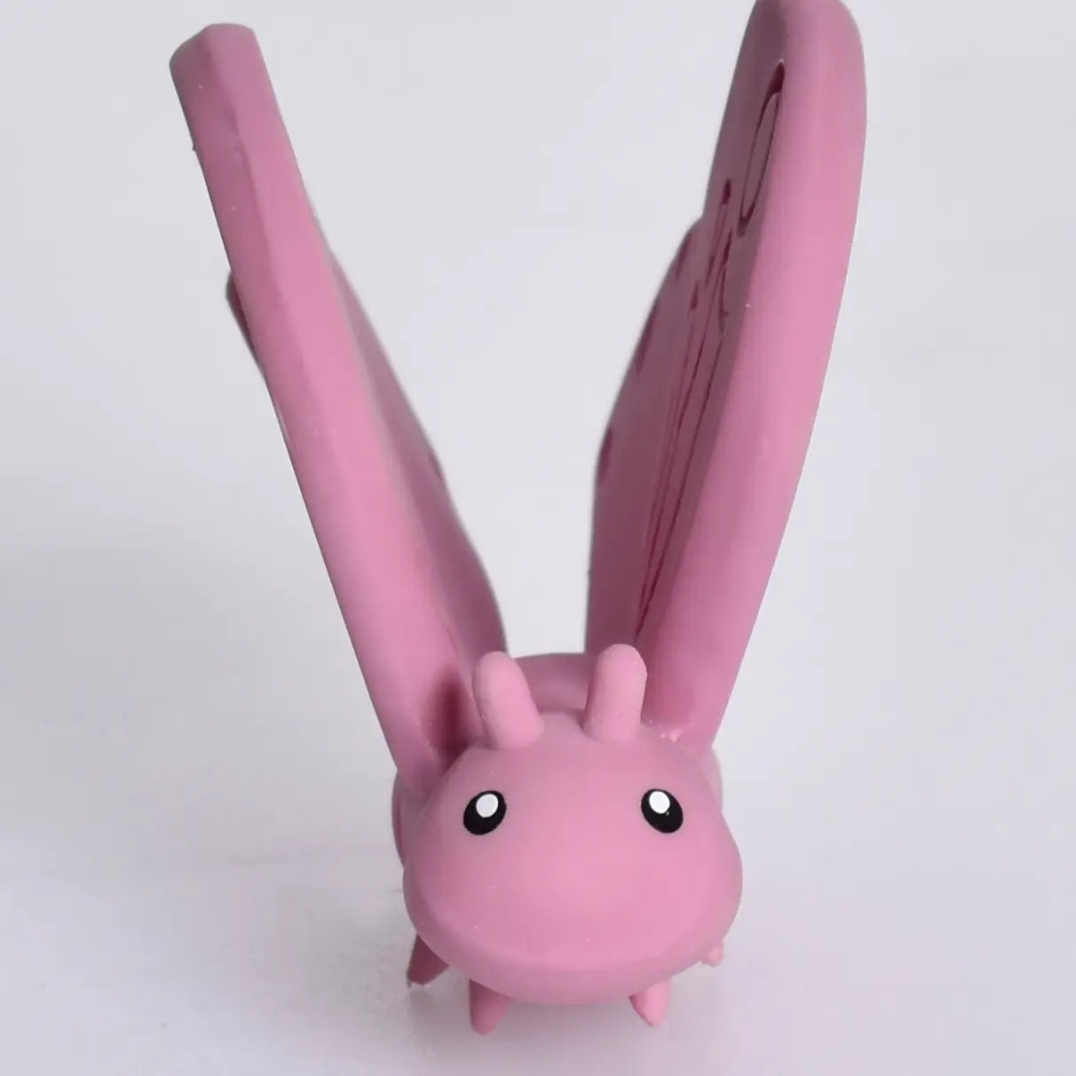 Organic Rubber Teether Rattle | Butterfly in pink, made of natural rubber with a soft and hard texture for soothing gums.