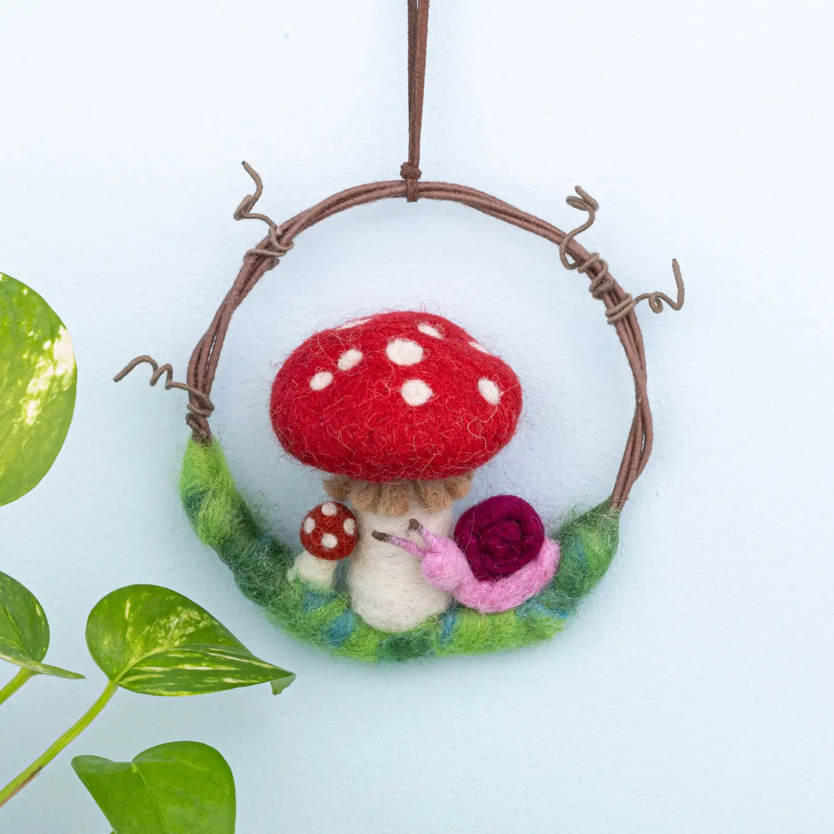 Mushroom Snail Wreath Felt Ornament featuring a red spotted mushroom and pink snail on a twig wreath.