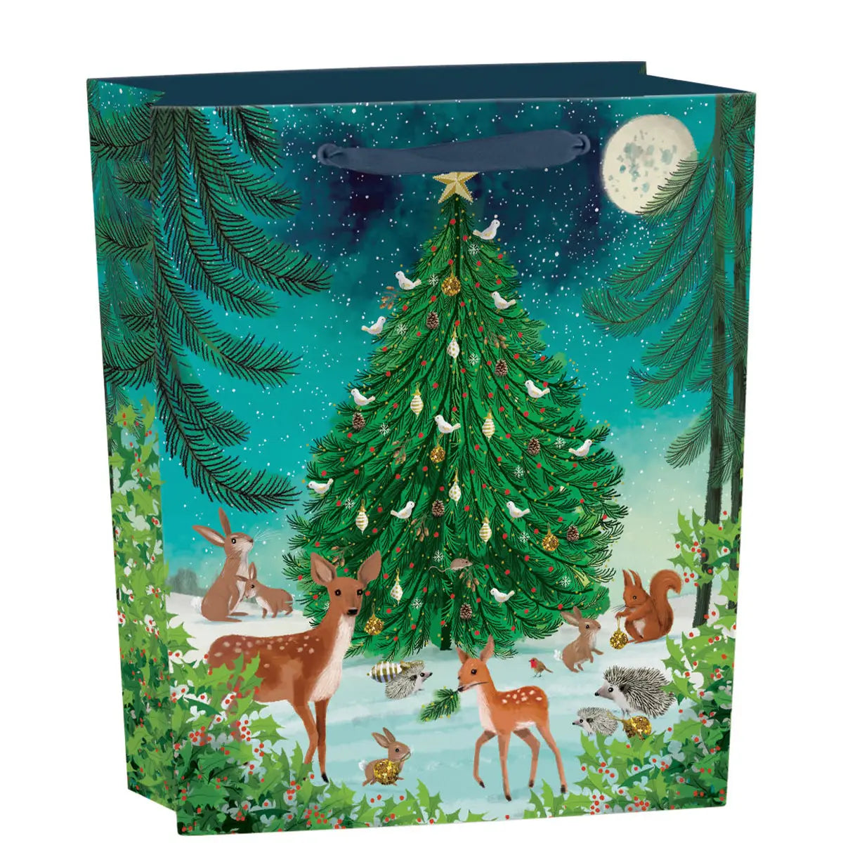 Heart of the Forest Gift Bag Medium with woodland animals and decorated Christmas tree under a moonlit sky.