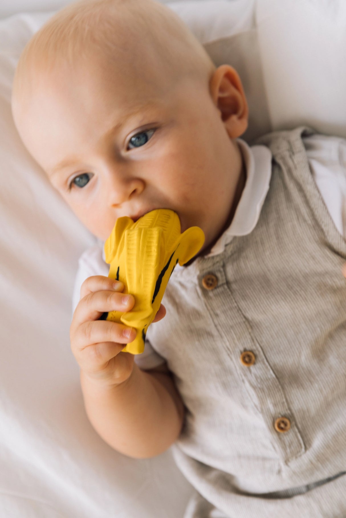 Baby chewing on Natural Teether | Ana the Banana Pop Art Edition, a soft, safe, hand-painted rubber teething toy.
