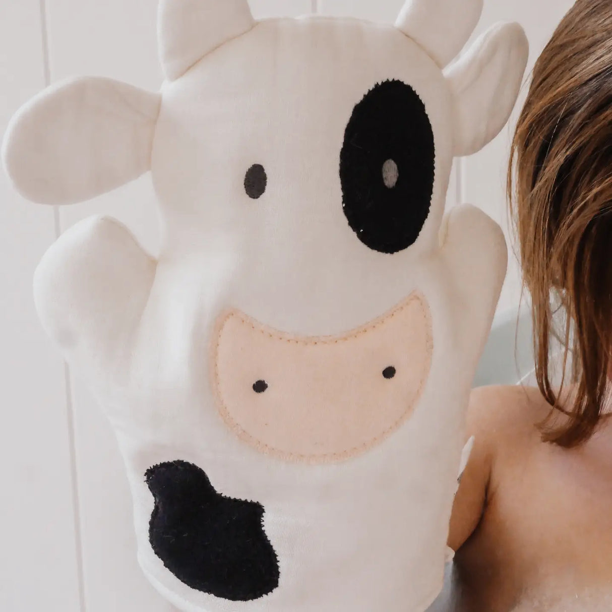 Farm Bath Mitt | Cow made of soft cotton muslin with embroidered details for gentle baby bath time and play.