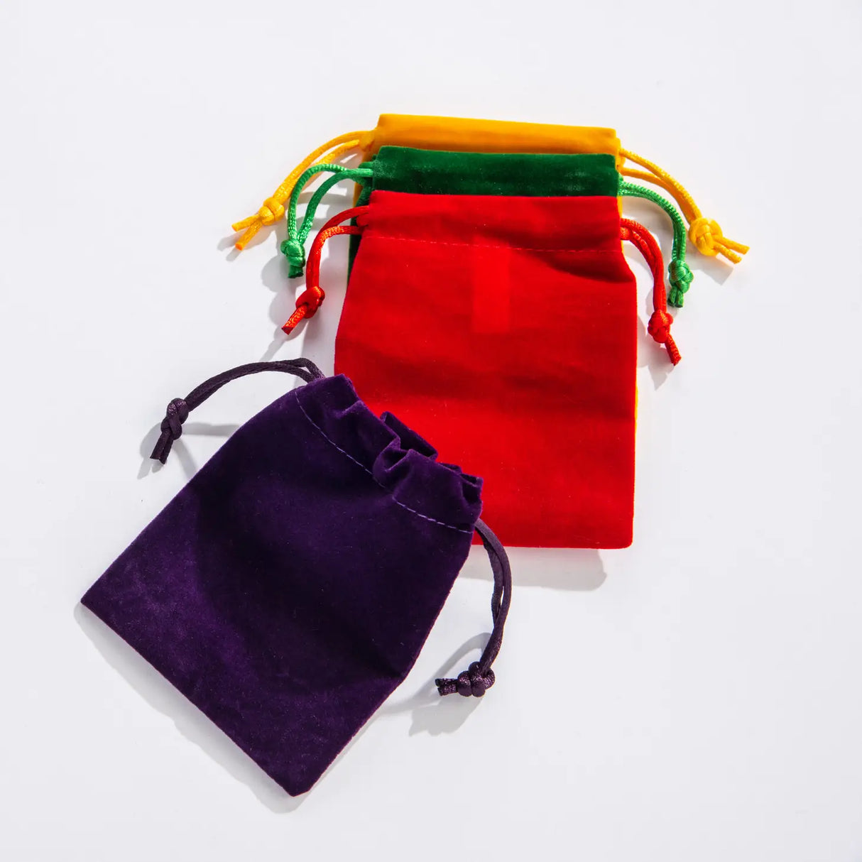 Velvet Pouch medium size drawstring bags in bright purple, red, green, and yellow colors for treasures and geodes