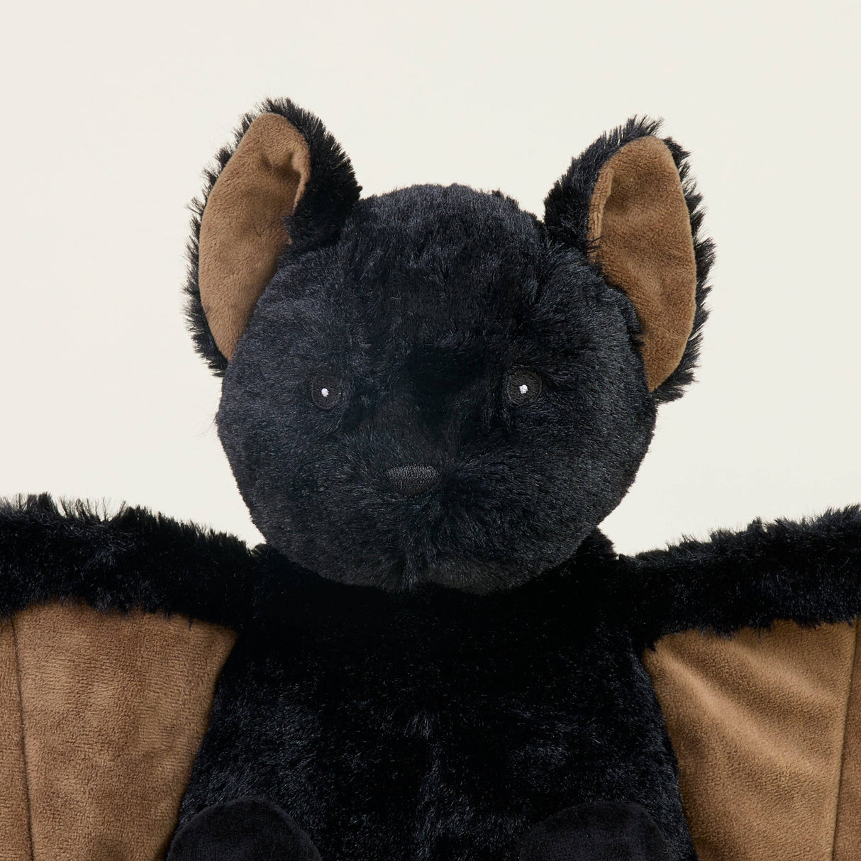Soft black and brown bat plush toy with detailed ears, designed for warmth and comfort with lavender scent.