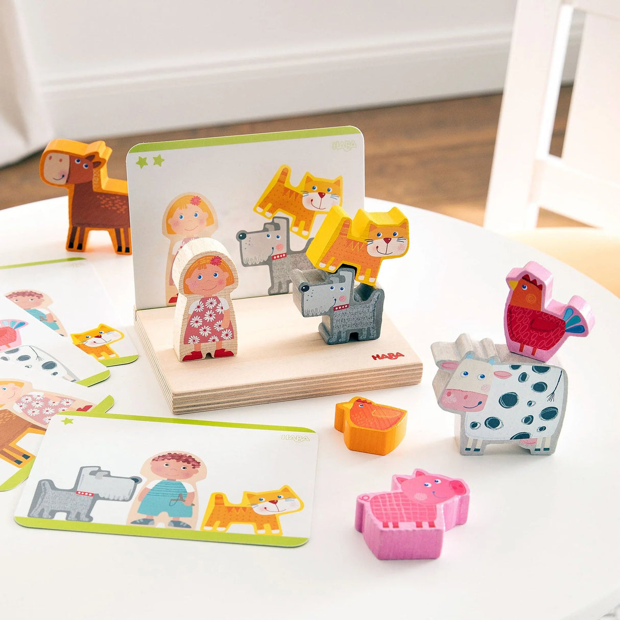 Wooden farm animal stacking toy with colorful animal and person pieces on a sturdy board and matching template cards
