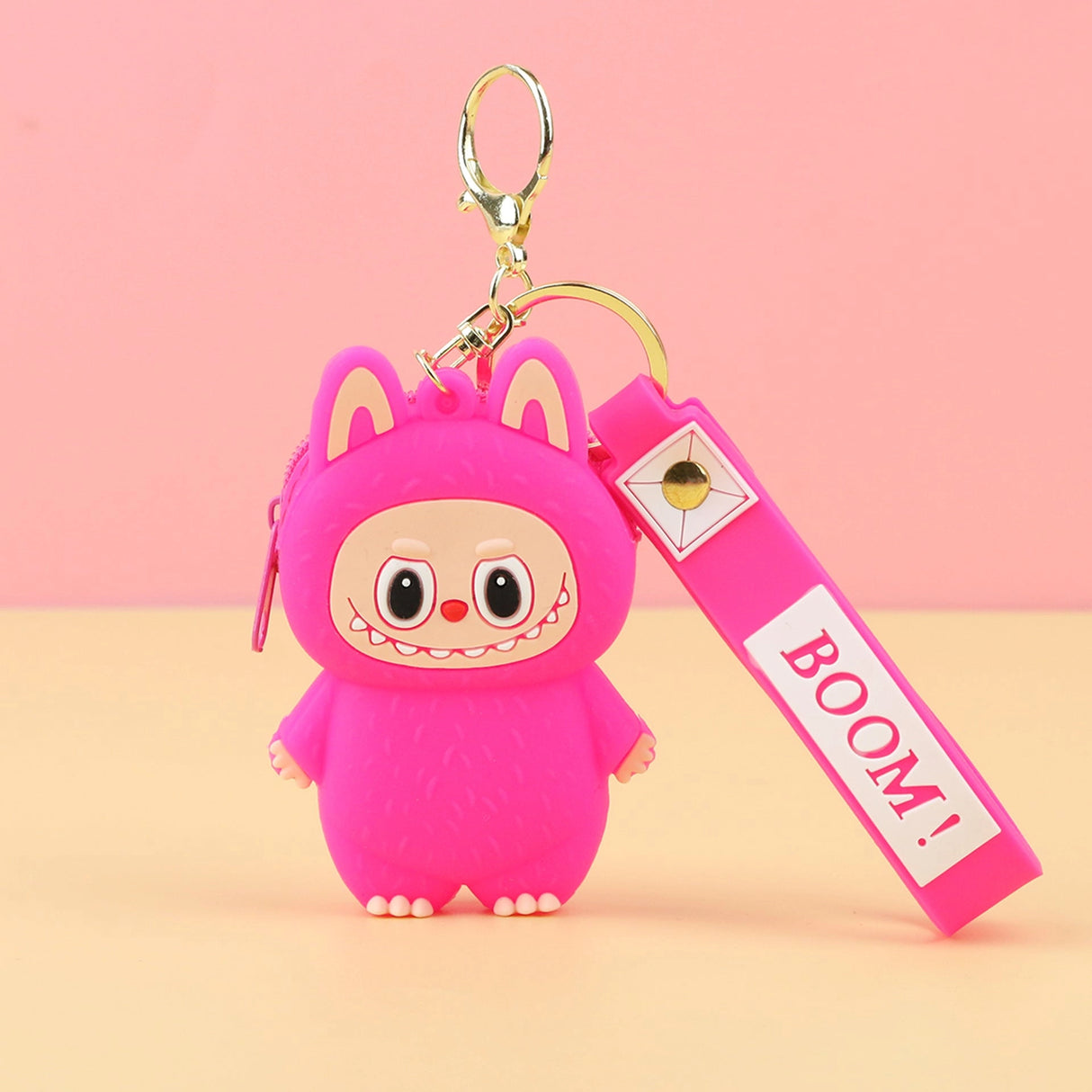 Labubu Cute Coin Purse in bright pink silicone with a smiley face and keychain accessory against a pink background.