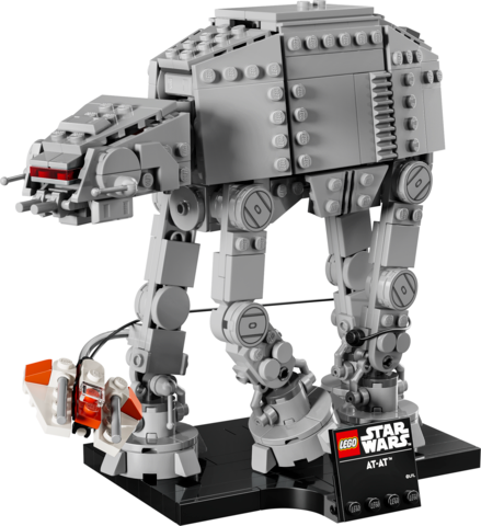 LEGO Star Wars model of an AT-AT walker with a Rebel snowspeeder wrapping a tow cable around its leg on a display stand