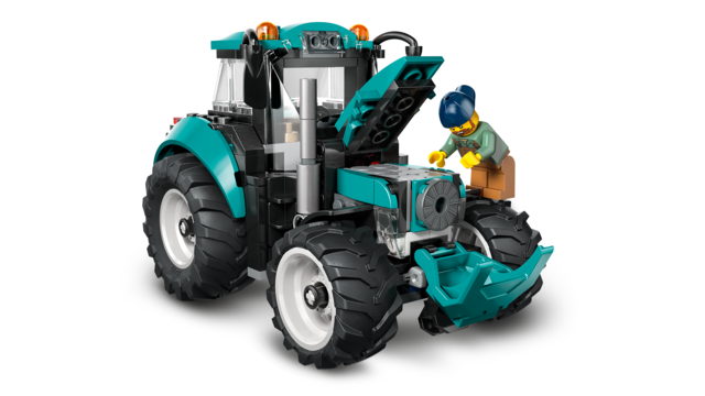 Toy city tractor with teal body, large rubber tires, and a minifigure farmer opening the hood.