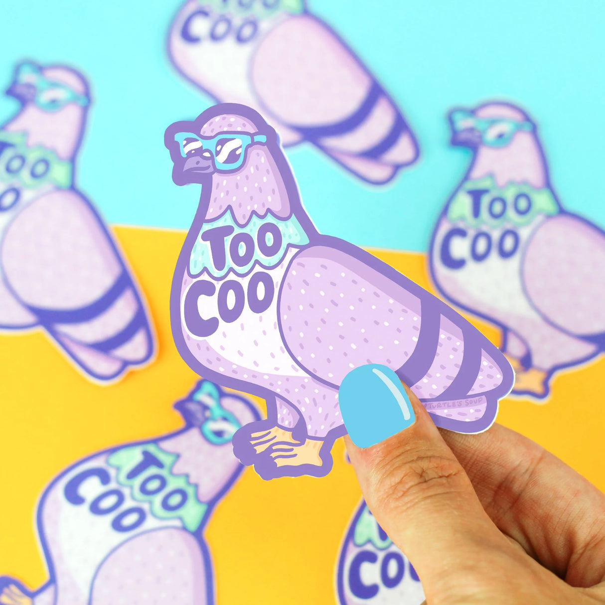 Hand holding a Too Coo Pigeon Sticker featuring a pigeon with sunglasses and playful text design.