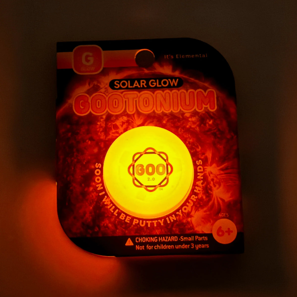 Gootonium: Glowing Orange Solar Putty package glowing against a dark background