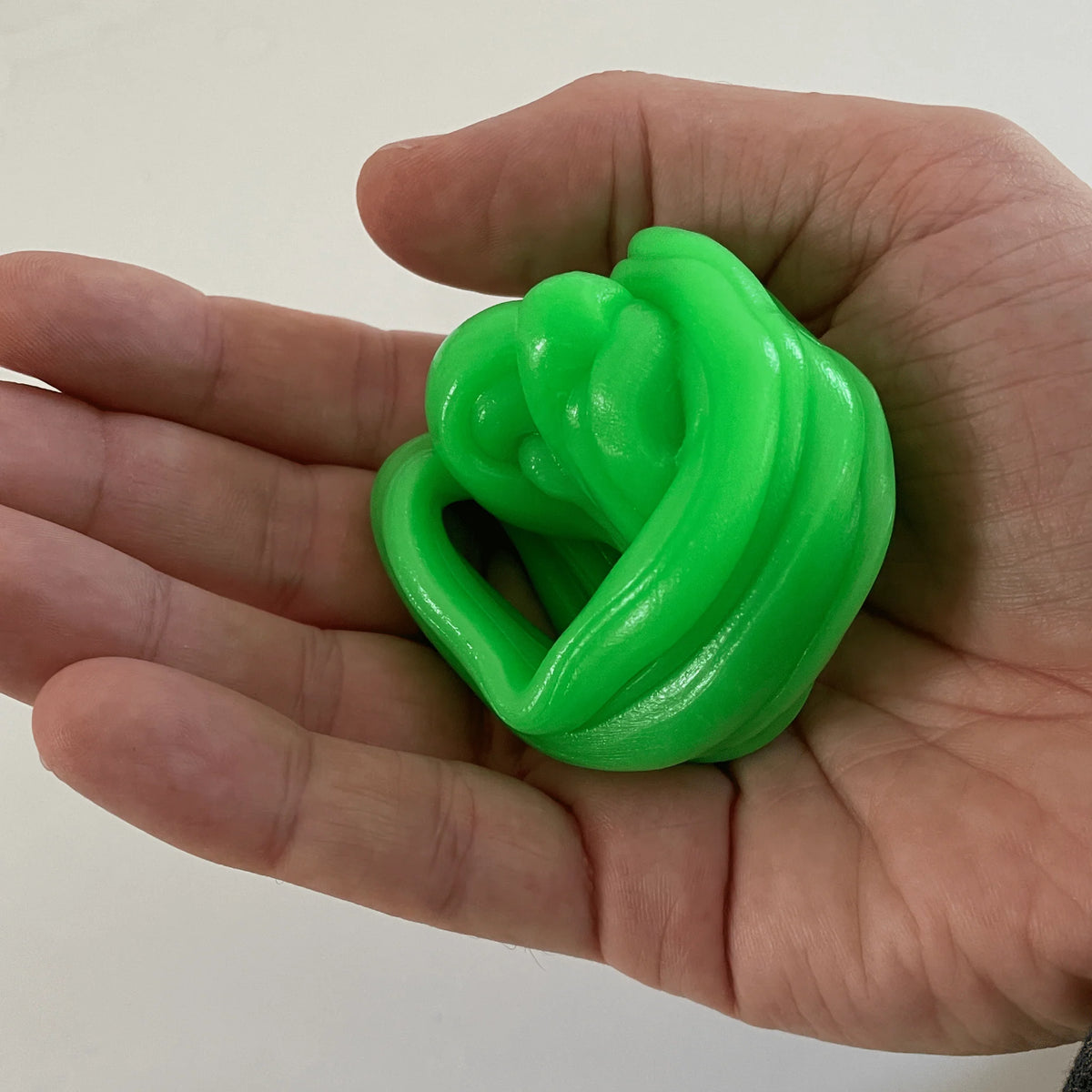 Gootonium: Glowing Brilliant Green Putty held in a hand