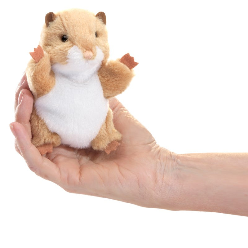 Hand holding a soft and sweet Mini Hamster Finger Puppet with movable head and forelegs for ages 3 and up.