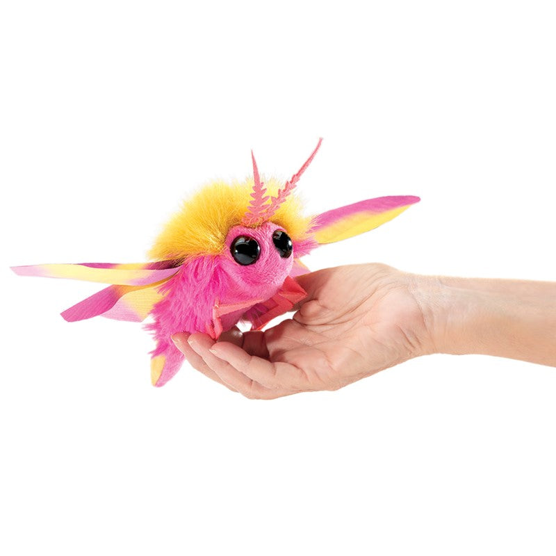 Rosy Maple Moth Finger Puppet with bright pink and yellow wings, big eyes, and fuzzy body held in hand.