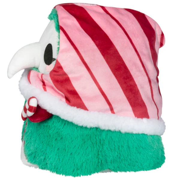 Soft festive plush figure with a white beak mask, red and pink striped hood, green furry body, and candy cane detail