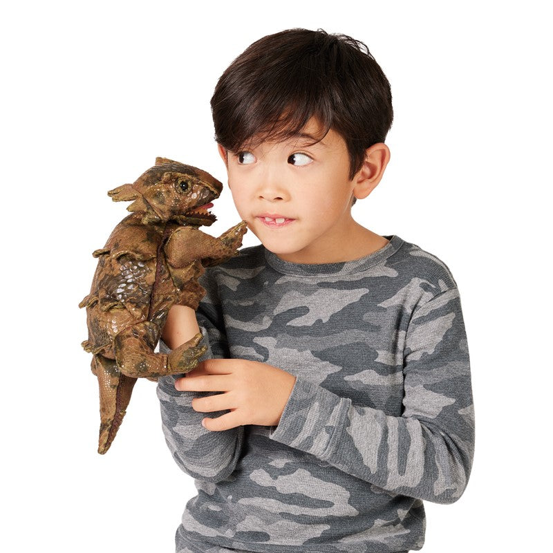 Child playing with a detailed Horned Lizard Puppet featuring movable mouth and forelegs for lifelike desert reptile play.