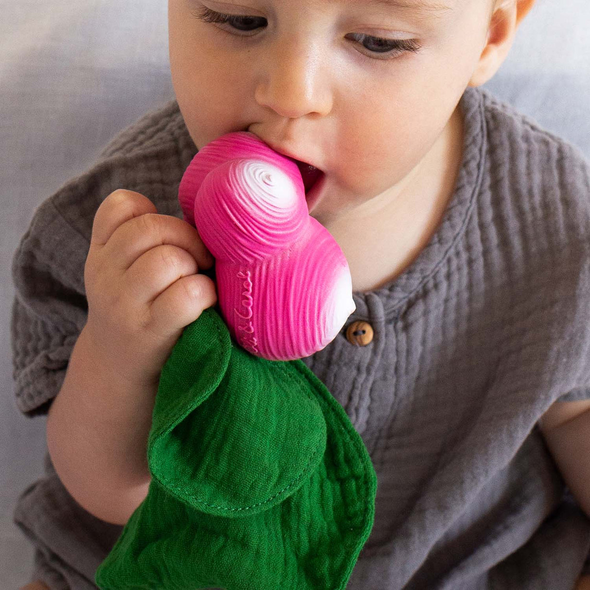 Baby chewing on Mini DouDou Teether | Ramona the Radish with soft green muslin for comfort and calming.