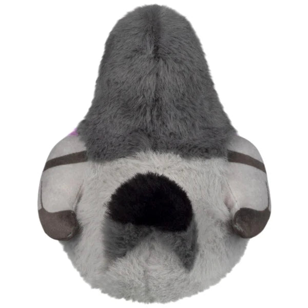 Back view of a soft gray plush animal with dark furry back and black patch