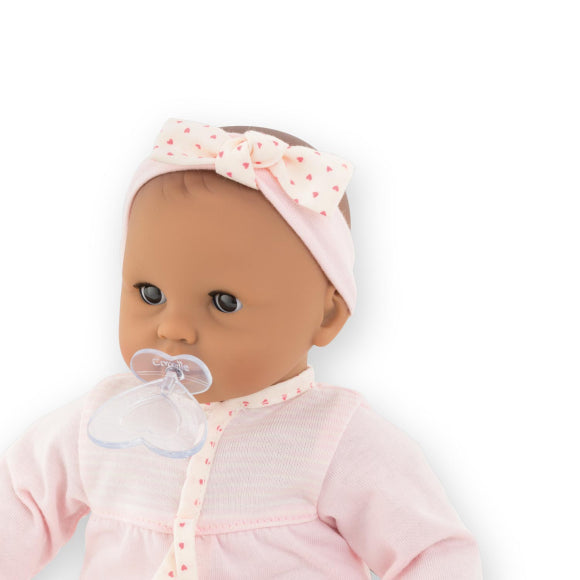 Pacifiers Set with heart-shaped pacifier soothing a 12-inch baby doll wearing pink outfit and headband.