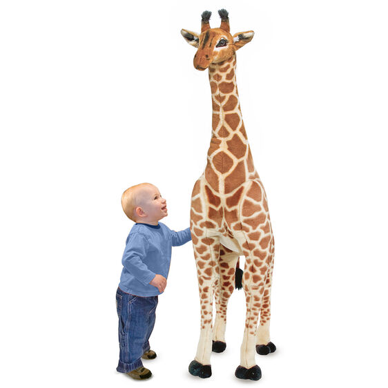 Child beside over four feet tall lifelike plush giraffe toy with realistic details, Giraffe BIG product.