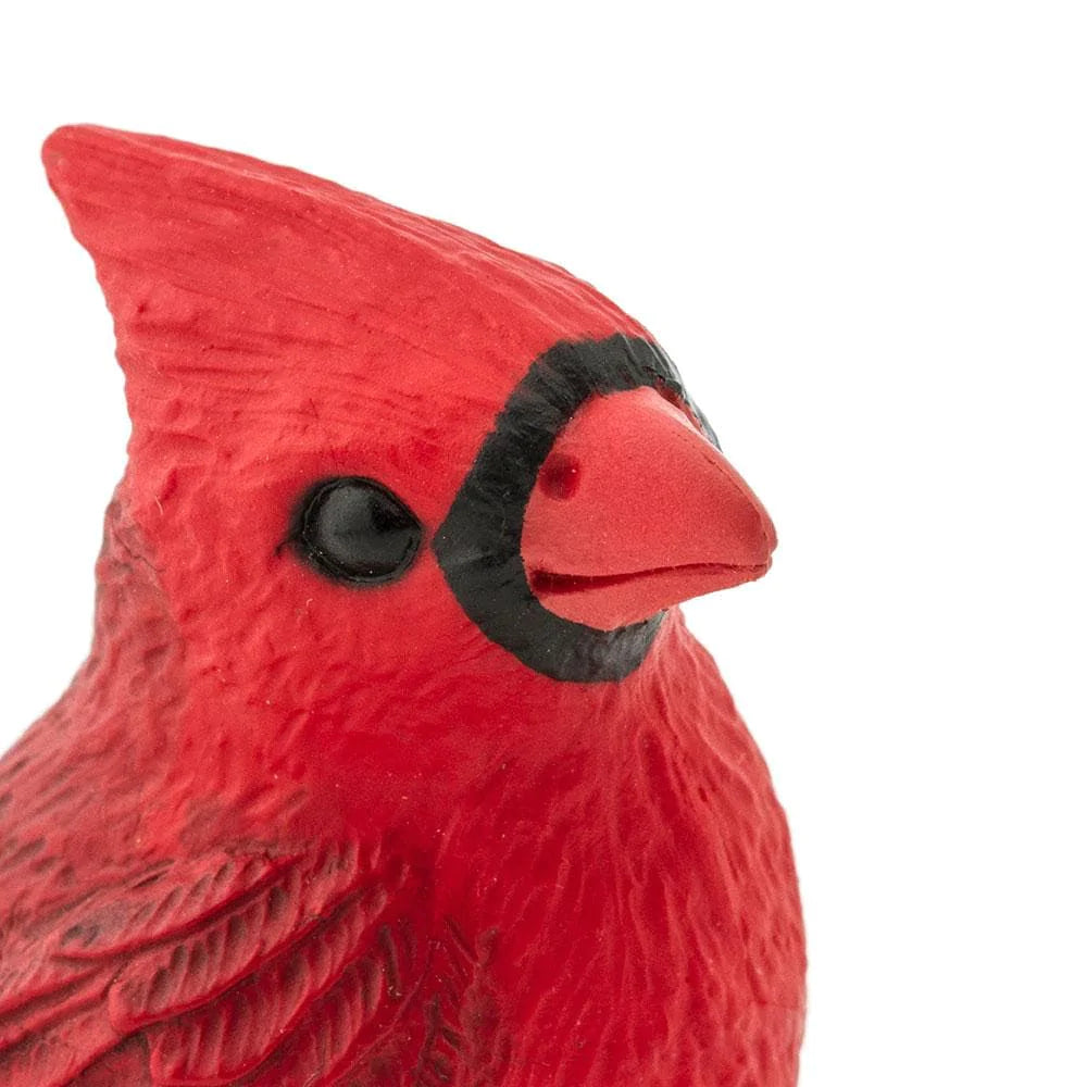 Close-up of the Cardinal figurine showing detailed hand-painted red feathers and black facial markings.
