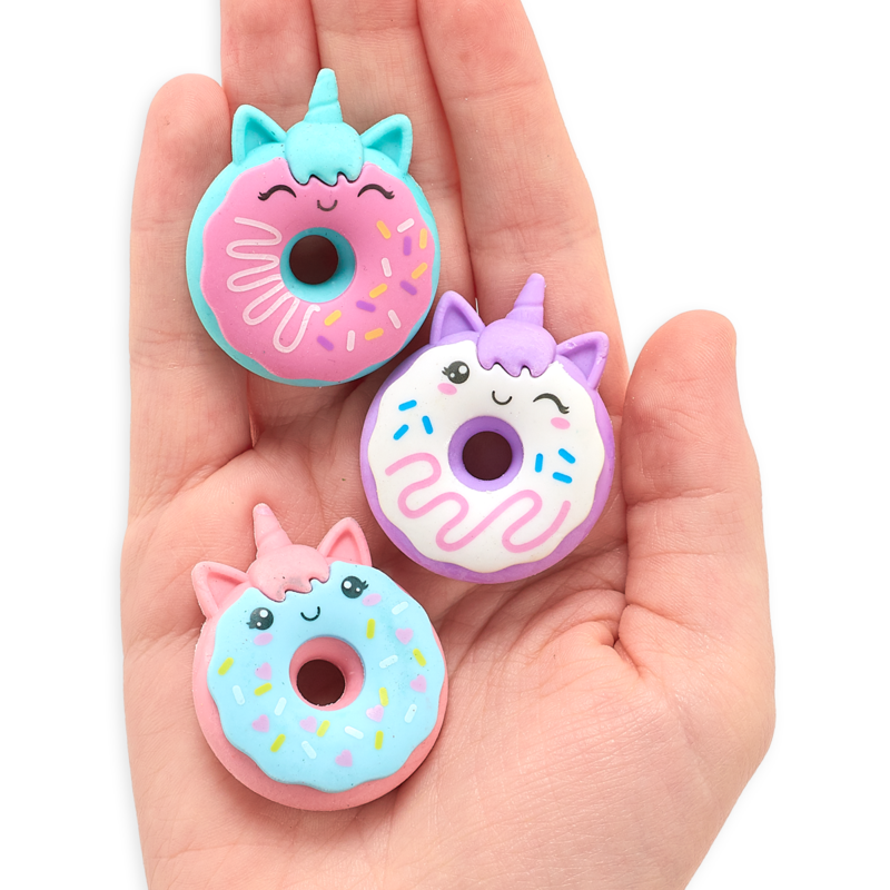 Hand holding three colorful Unicorn Donuts Puzzle Erasers with smiling faces and unicorn horns.
