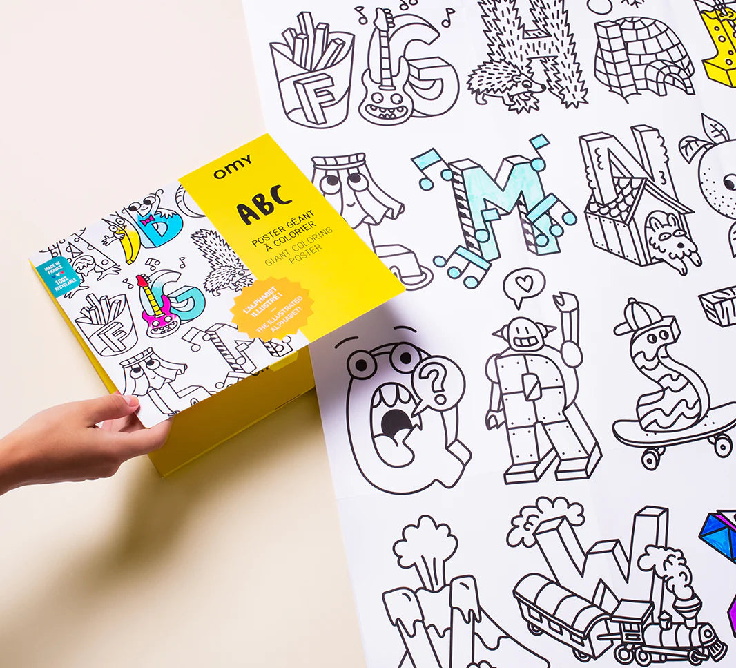 Hand holding box next to partially colored ABC Giant Coloring Poster featuring cartoon letters and pictures to color.