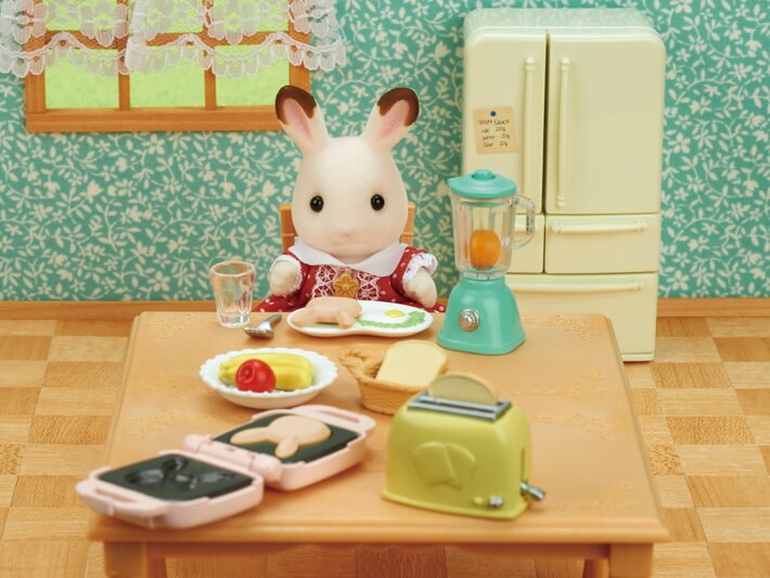 Breakfast Playset featuring a bunny figure with breakfast items, toaster, blender, and cooking utensils on a table.