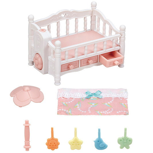 Crib with Mobile in white and pink with rotating mobile, storage drawers, and convertible footboard bench for baby triplets.