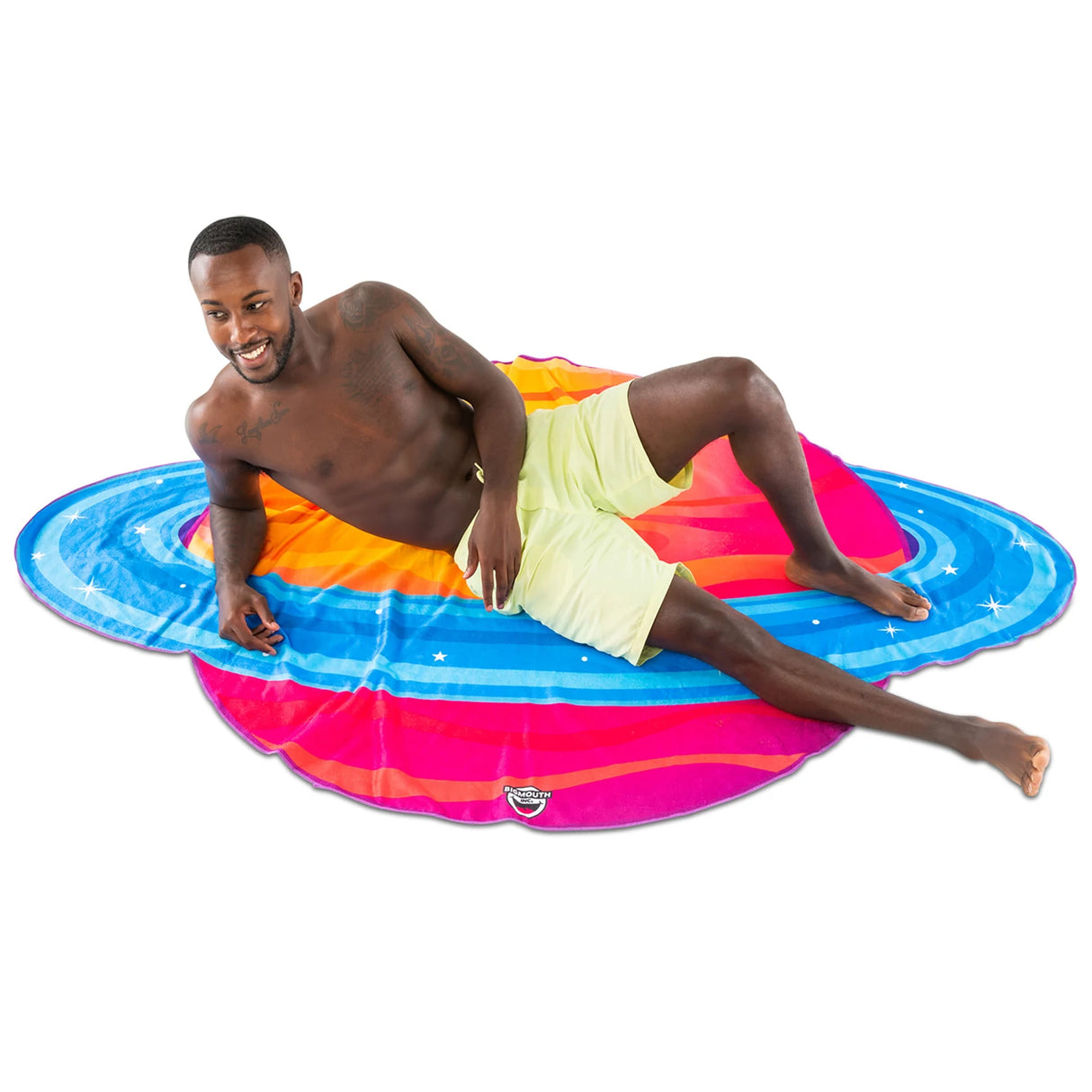Man relaxing on colorful, ultra-soft Beach Blanket | Planet, five feet wide and perfect for outdoor use.