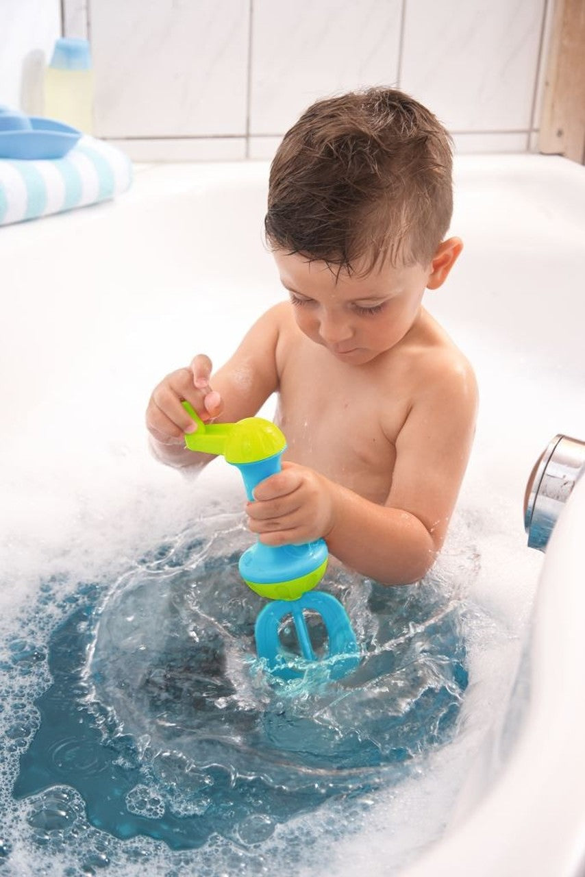 Child playing in bathtub using the bubble bath whisk | Blue to create foaming bubbles during bath time.