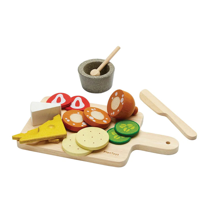 Charcuterie Board with wooden cheese, salami, crackers, cucumbers, knife, sauce cup, spoon, and cutting board set for kids.