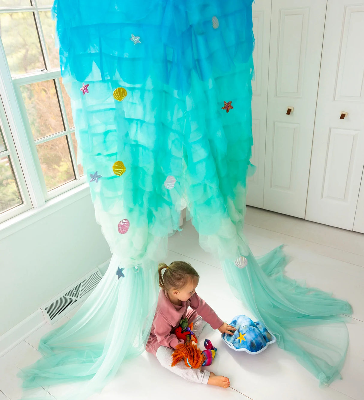 Light-Up Mermaid Canopy in blue ombré with LED lights and fabric sea creature appliqués, child playing inside.