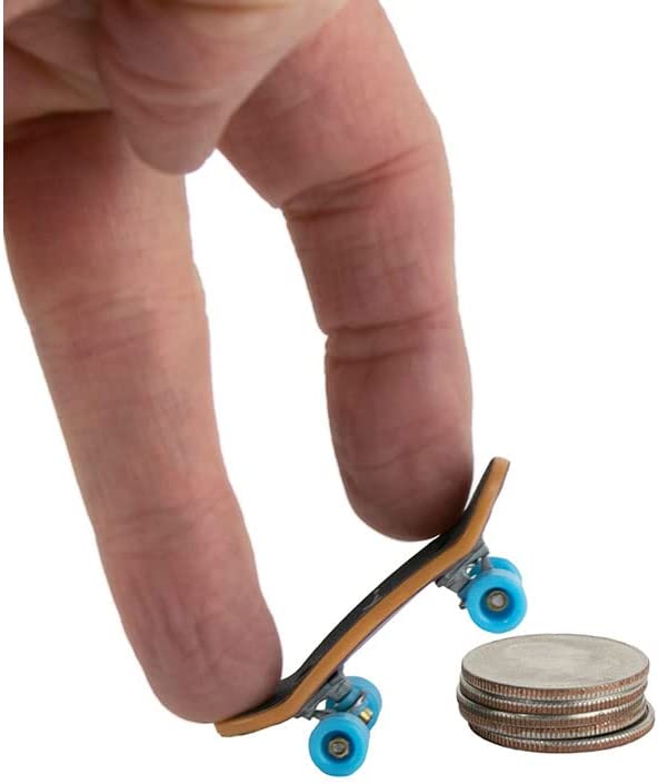 Hand holding the world's smallest Tech Deck fingerboard next to stacked coins for size comparison.