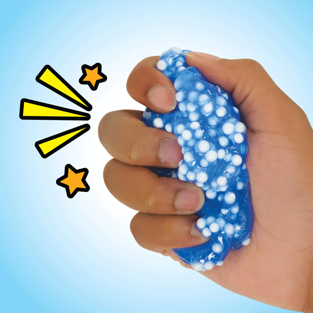Hand squeezing blue Popp'n Crackle'N Kraken Thinking Putty with white tentacle-like beads against a light blue background.