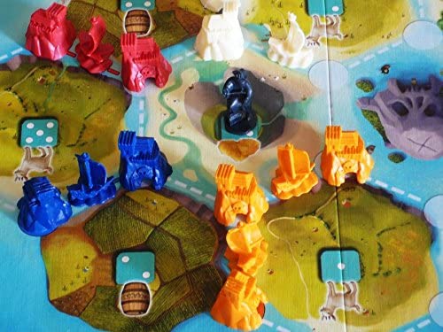 Catan Jr. game board with colorful pirate hideouts and ships set on island territories for kids aged 5 and up.