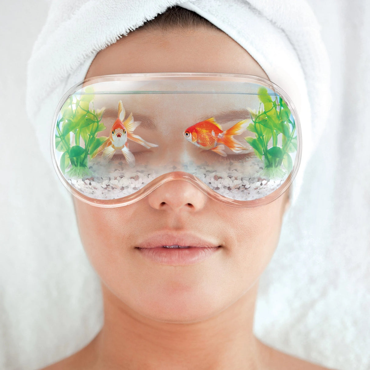 Close-up of a person wearing the Chill Out! Eye Mask Fishbowl with gel and goldfish design for refreshing eyes.