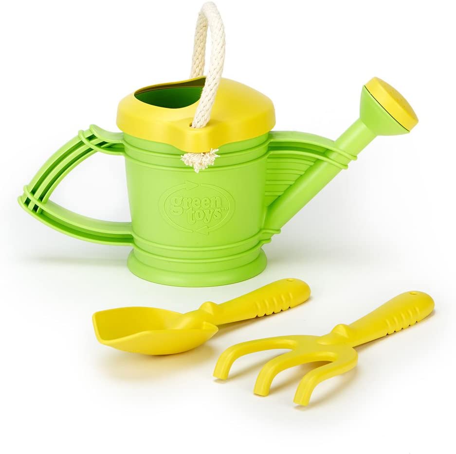Green Toys Watering Can with yellow spout, cotton rope handle, rake, and shovel for kids' gardening fun.