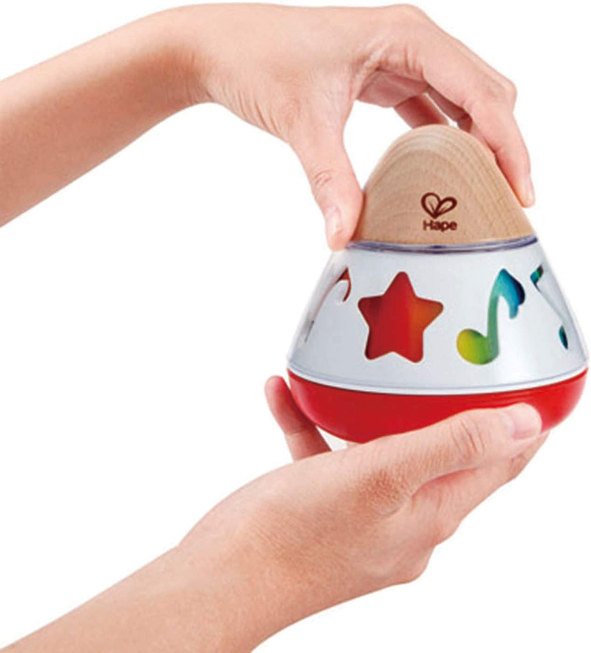 Hands holding the Music Box with color-changing musical symbols on a wooden and red base design.