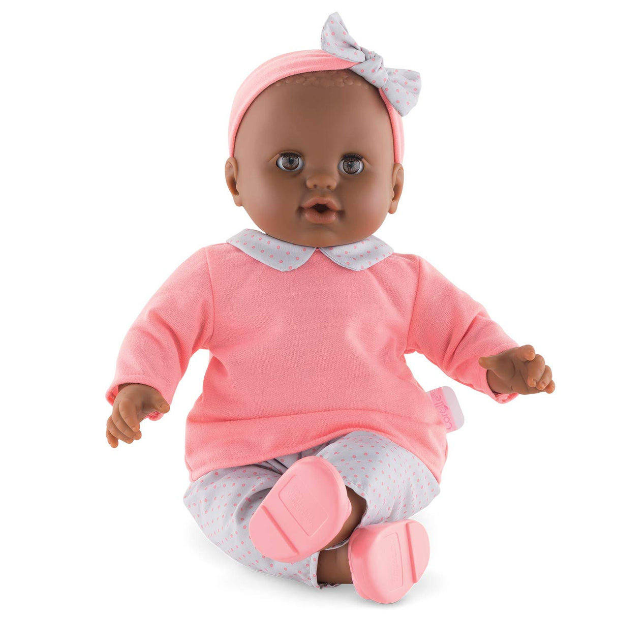 Grand Poupon Lilou baby doll dressed in pink outfit with headband, designed for cuddling and caring play.