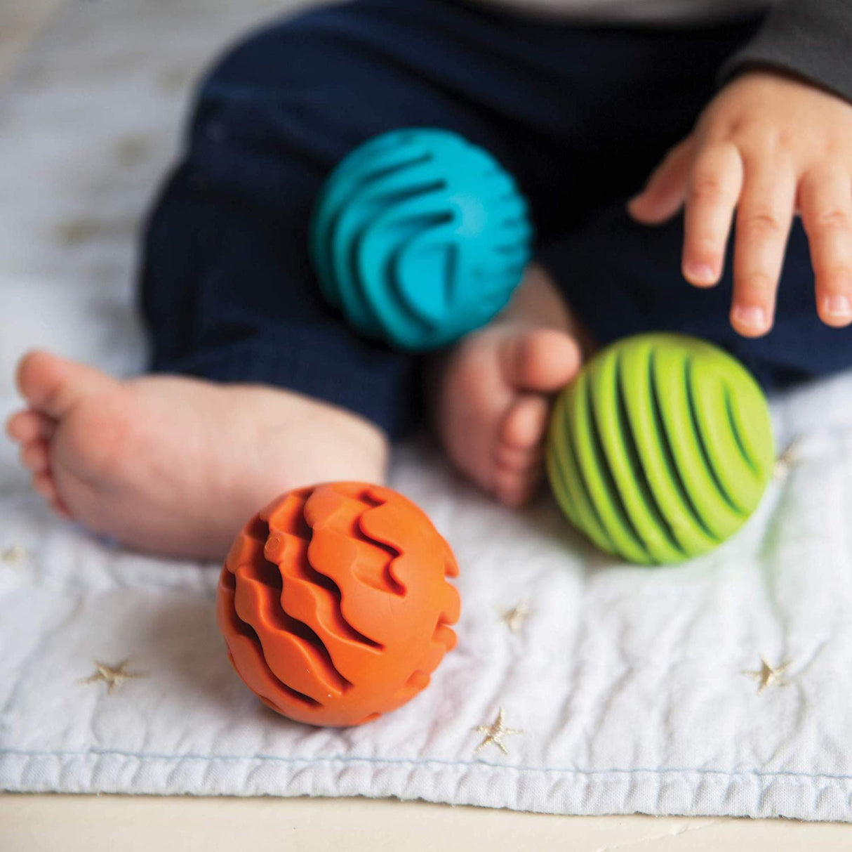 Sensory Rollers set of three textured silicone spheres in orange, green, and blue for tactile and sensory play.