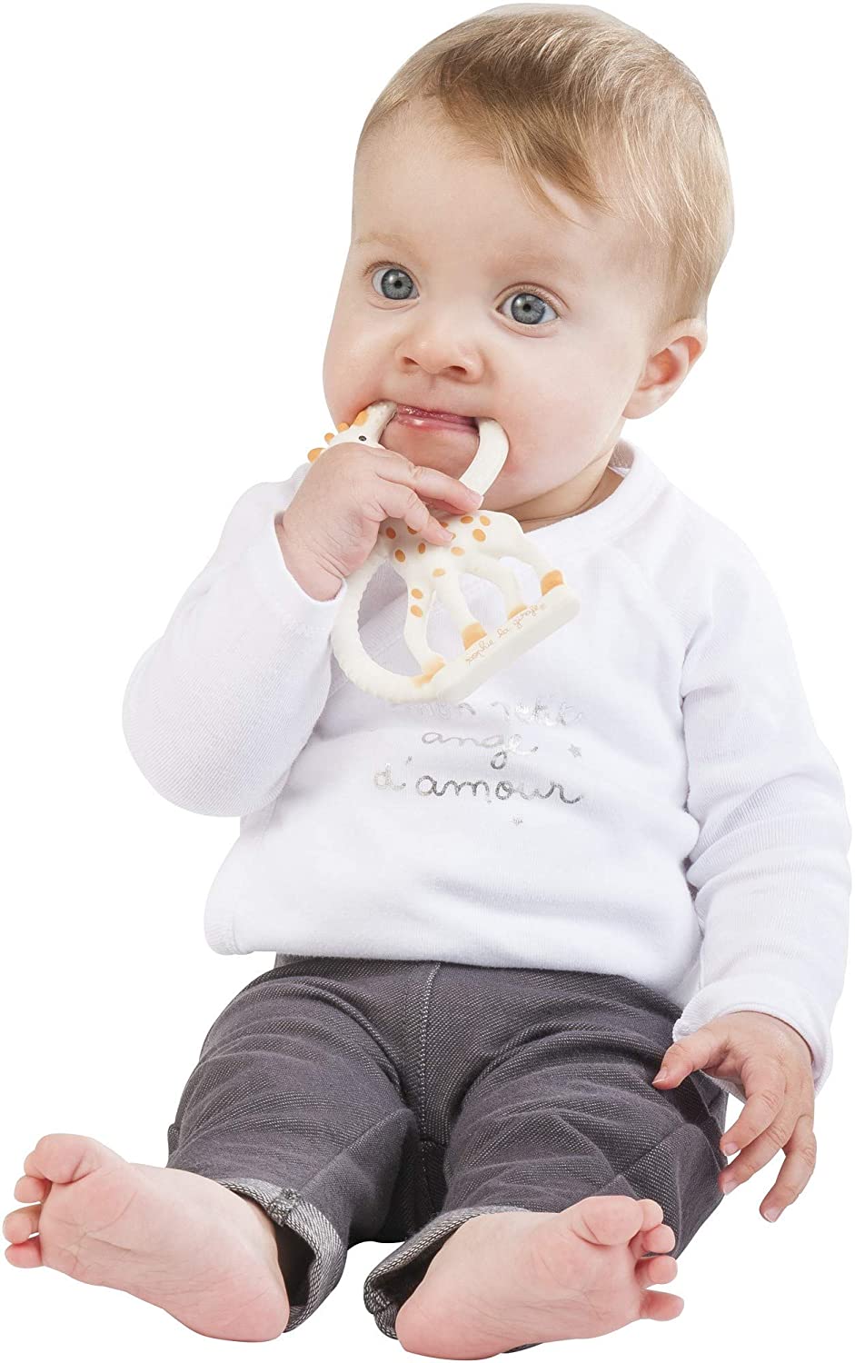 Baby holding and chewing on Sophie the Giraffe Teether with textured natural rubber rings for soothing gums.