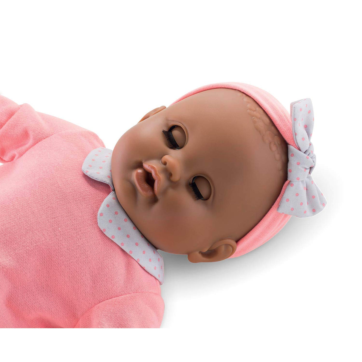 Grand Poupon Lilou doll with sleeping eyes, soft touch vinyl, dressed in pink outfit with headband and bow.