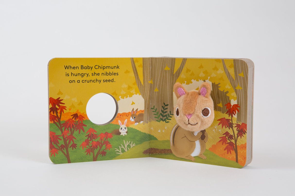 Baby Chipmunk with Finger Puppet board book open to a colorful forest scene with a plush chipmunk puppet.