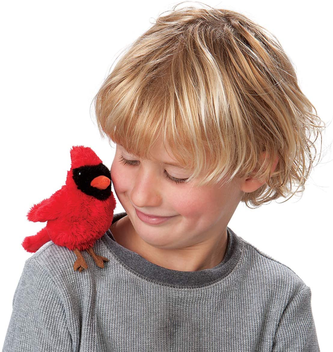 Child smiling with a red Cardinal Finger Puppet perched on shoulder, showcasing a playful bird toy.